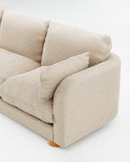 Miles treseters sofa i beige bouclé med sylindriske eikeben