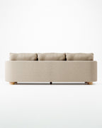 Miles treseters sofa i beige bouclé med sylindriske eikeben
